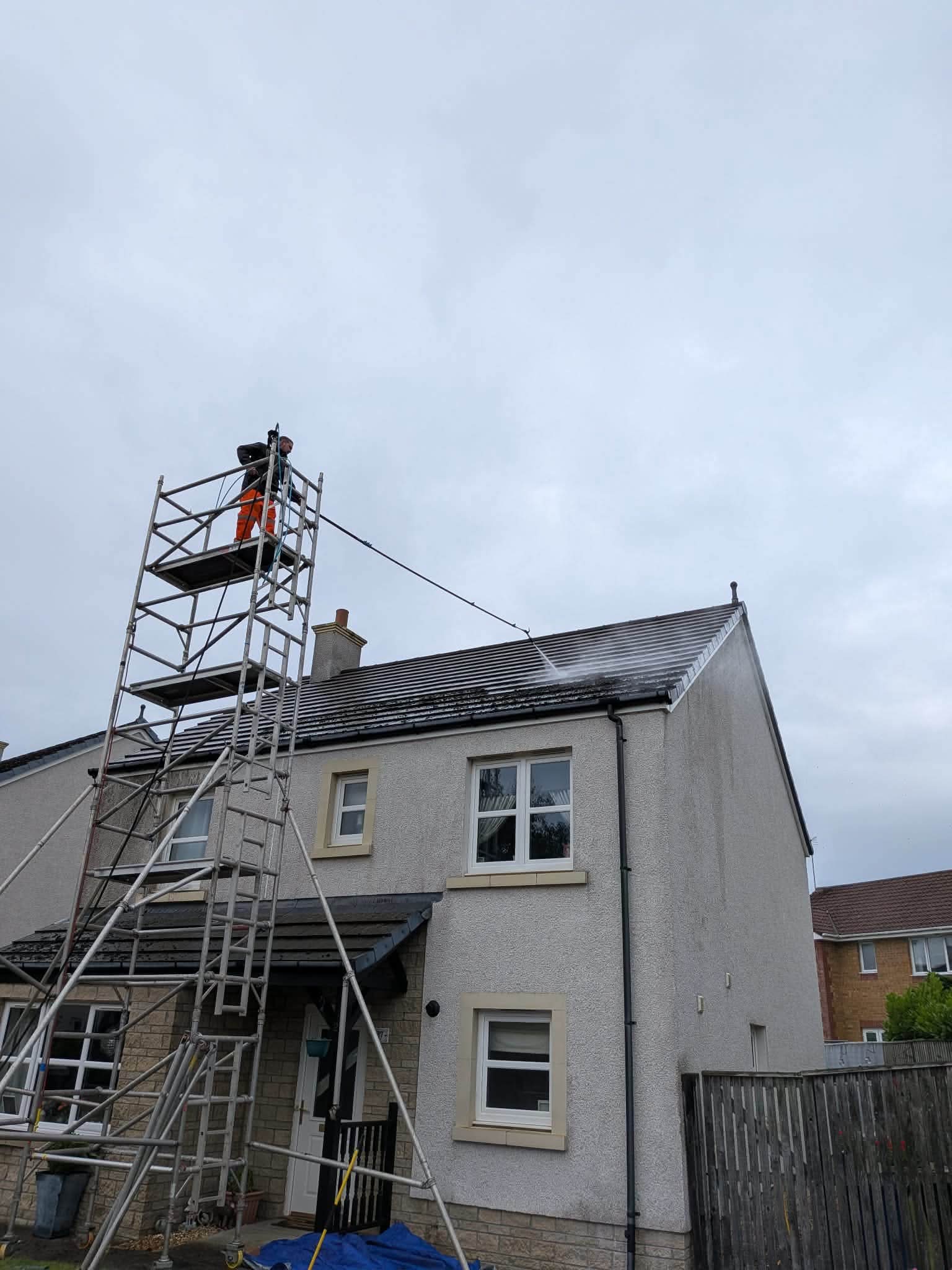 Dirty Deeds roof cleaning technician at work on scaffolding in Ayrshire